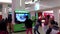 Microsoft staff demonstrates with children dance game at the mall