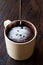 Microwave Brownie Chocolate Mug Cake with Powder Sugar on Dark Wooden Surface.