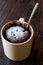 Microwave Brownie Chocolate Mug Cake with Powder Sugar on Dark Wooden Surface.