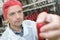 Mid adult industrial worker looking at bottle in factory