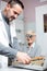 Mid adult male ophthalmologist examining senior female patient in a clinic