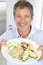 Mid Adult Man Holding Plate Of Healthy Food