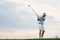 Mid-adult man playing golf against sky