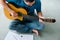 Mid Adult Man Reading Acoustic Guitar Sheet Music In Apartment