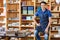 Mid Adult Salesman Sitting On Ladder In Book Store