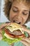 Mid Adult Woman Eating A Burger