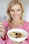 Mid Adult Woman Eating Porridge With Fresh Fruit