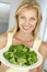 Mid Adult Woman Holding A Plate Of Broccoli