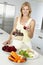 Mid Adult Woman Making Fresh Vegetable Juice