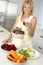 Mid Adult Woman Making Fresh Vegetable Juice