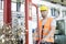 Mid adult worker pulling hand truck with steel shavings in factory