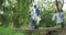 Mid adults volunteering and walking on a bridge during river clean-up day