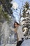 Mid aged cute smiling woman playing with snow