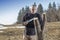 Mid aged man gardener sawing, cutting fruit tree