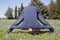 Mid aged woman doing yoga exercises outside