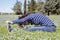 Mid aged woman doing yoga exercises outside