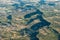 Mid-air view of green hills and cultivated land near Forcalquier