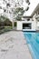 Mid century home with in ground pool and grey crazy paving