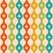 Mid century modern atomic starbursts over colorful ogee ovals seamless pattern in green, teal, orange and mustard yellow.