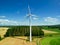 Mid level aspect aerial view of a wind turbine in a small rural wind farm