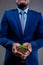 Mid section of african american businessman holding a seedling against grey background