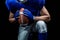 Mid section of American football player kneeling while holding ball