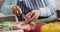 Mid section of asian senior woman chopping onions in the kitchen at home