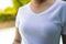 Mid section of biracial woman wearing white tshirt over swimming pool in garden