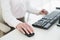 Mid section of businesswoman using mouse in office