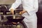 Mid section of a chef preparing food in kitchen