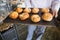 Mid section of chef showing tray of bread