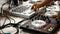 Mid section close up of DJ playing music in trendy club. Stock footage. Close up of a man playing on a dj console