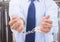 Mid section of corrupt businessman in hand cuffs