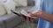 Mid section of Female health worker wiping her smartphone with a tissue