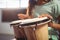 Mid section of girl playing bongo drums in classroom