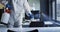 Mid section of health worker wearing protective clothes cleaning the office using disinfectant spray