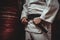 Mid section of karate player tying his belt