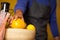 Mid-section of male staff holding lemon fruit at organic section