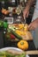 Mid section on man cutting yellow bell pepper in kitchen