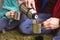 Mid section of man pouring coffee in a cup while sitting in a tent in the garden