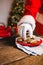 Mid-section of Santa Claus selecting cookie of plate