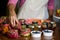 Mid-section of staff arranging jar at counter