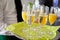 Mid section view of waiter serving champagne and orange juice on