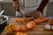 Mid section of woman cutting carrot at counter