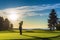 A Mid-Swing Golfer Silhouette Against a Vibrant Green Golf Course Under a Clear Blue Sky