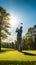 A Mid-Swing Golfer Silhouette Against a Vibrant Green Golf Course Under a Clear Blue Sky