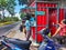 Midday Refreshment: Shoppers Queuing at the Beverage Vendor