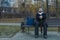 Middle adult calm bearded man sitting on bench lonely melancholy mood in autumn park dray ordinary day