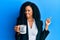 Middle age african american woman drinking from i am the boss coffee cup smiling happy pointing with hand and finger to the side