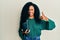 Middle age african american woman holding oil motor bottle smiling happy and positive, thumb up doing excellent and approval sign